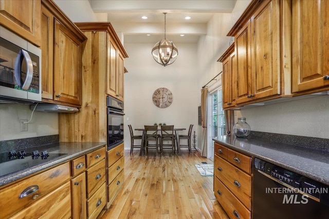 1037 Pahsimeroi Dr, Twin Falls, ID 83301 - kitchen with black appliances, brown cabinets, a chandelier, light wood finished floors, and a high ceiling