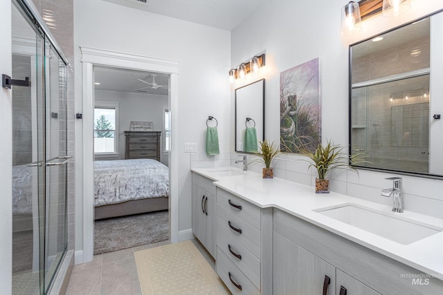 bathroom featuring tile patterned flooring, vanity, a shower with door, and ceiling fan