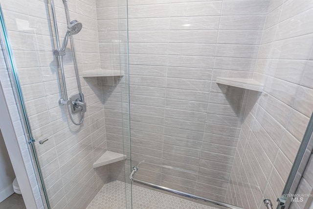 bathroom with a shower with shower door