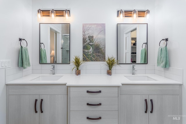 bathroom with vanity and tasteful backsplash