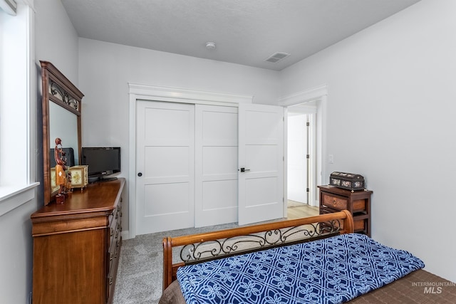 carpeted bedroom featuring a closet