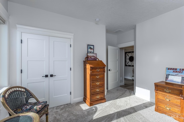 bedroom with light carpet and a closet