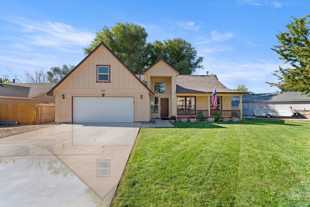 view of front of house featuring a garage, a front lawn, and a porch