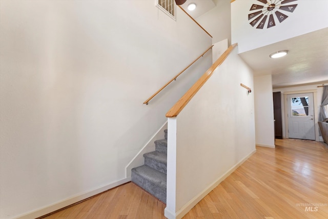 staircase featuring wood-type flooring