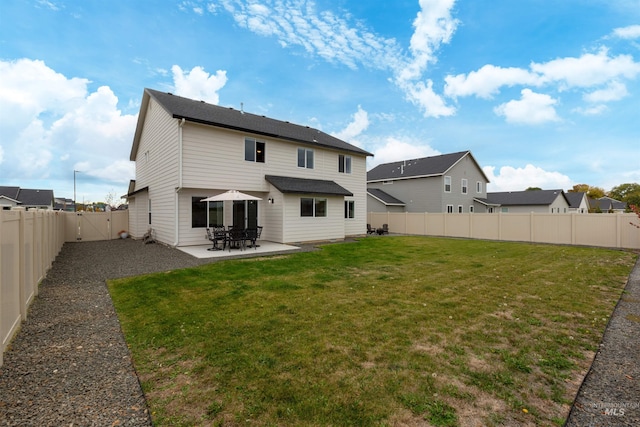 back of house with a patio and a lawn