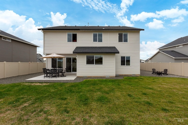 rear view of house featuring a patio and a yard