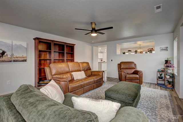 living room with light hardwood / wood-style floors and ceiling fan