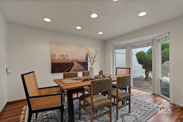 dining area with recessed lighting, baseboards, a textured ceiling, and wood finished floors