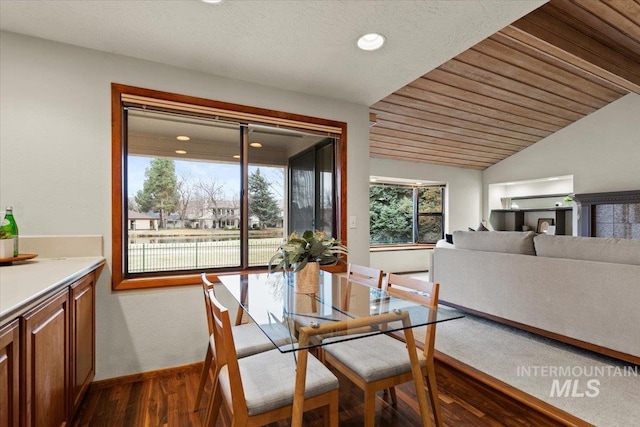 dining area with vaulted ceiling, wooden ceiling, baseboards, and dark wood-style flooring