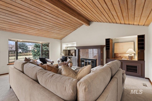 carpeted living room featuring baseboards, visible vents, lofted ceiling with beams, a tile fireplace, and wood ceiling