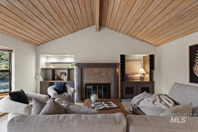 living area featuring wood ceiling, a fireplace, and vaulted ceiling