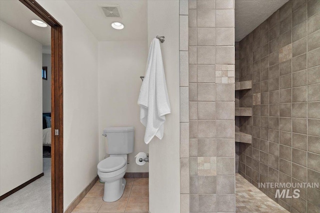 full bath with tile patterned floors, visible vents, toilet, a walk in shower, and ensuite bath