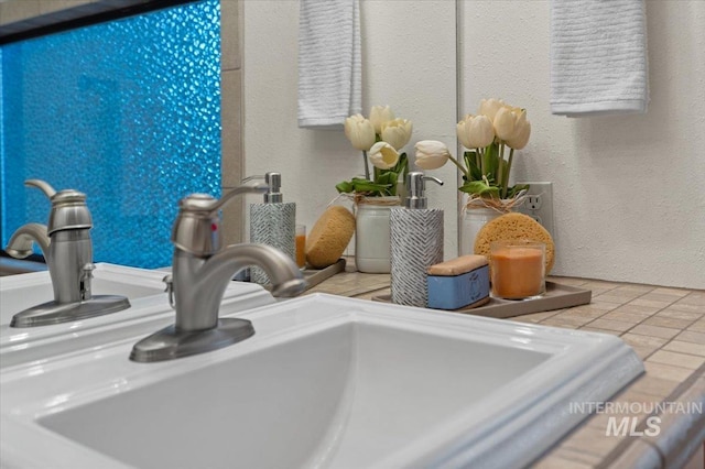 details with a textured wall and a sink