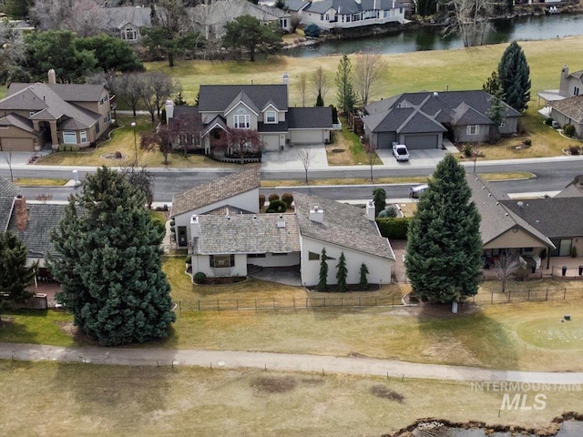 drone / aerial view featuring a residential view and a water view