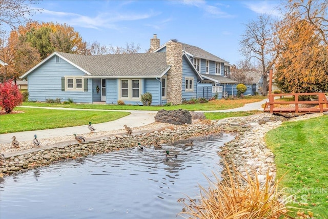 exterior space with a water view and a front yard