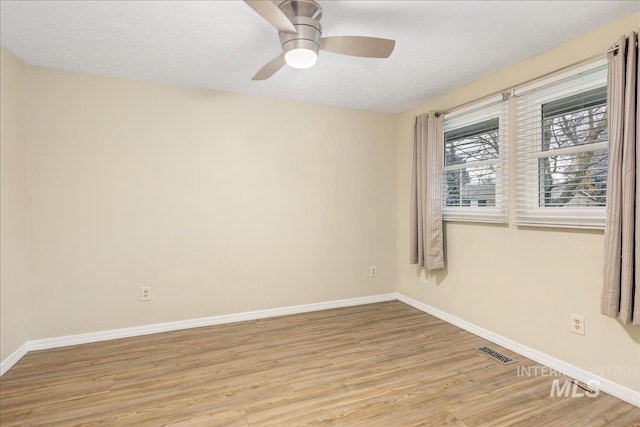 spare room featuring ceiling fan, a textured ceiling, and light hardwood / wood-style floors