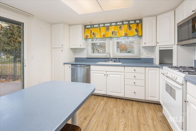 kitchen with white cabinetry, sink, and appliances with stainless steel finishes