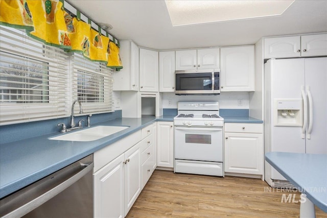 kitchen featuring appliances with stainless steel finishes, sink, and white cabinets