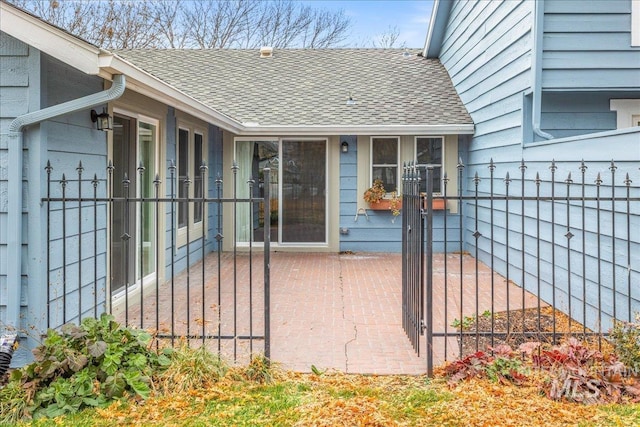 view of exterior entry with a patio area