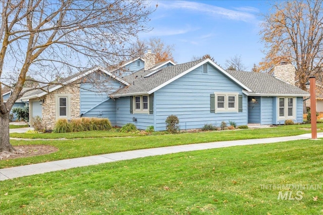 view of front of property featuring a garage and a front lawn