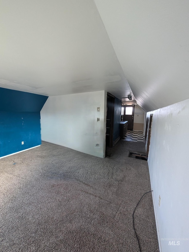 additional living space featuring carpet and vaulted ceiling