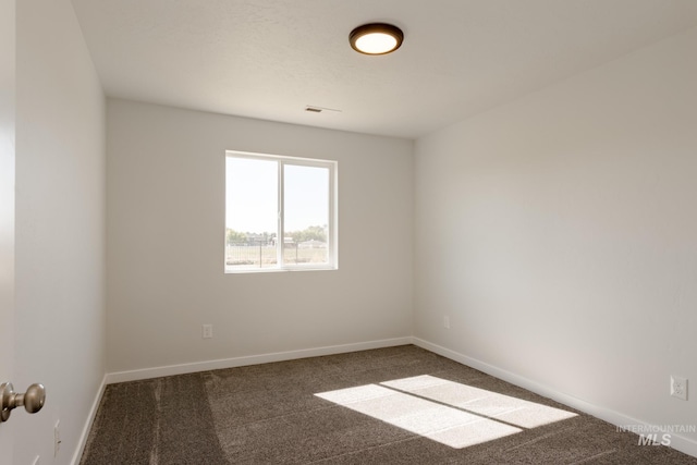 carpeted empty room featuring visible vents and baseboards