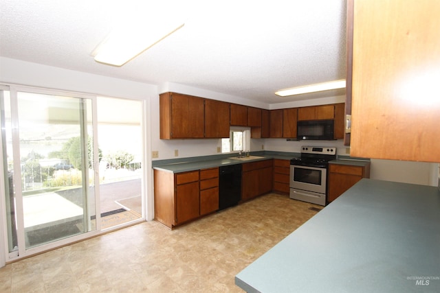 930 Coulter Ln, Clarkston, WA 99403 - kitchen with black appliances, brown cabinetry, a sink, light floors, and a textured ceiling
