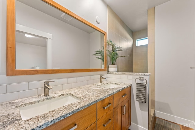 bathroom featuring tasteful backsplash and vanity