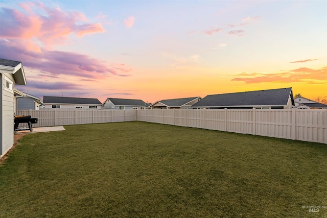 view of yard at dusk