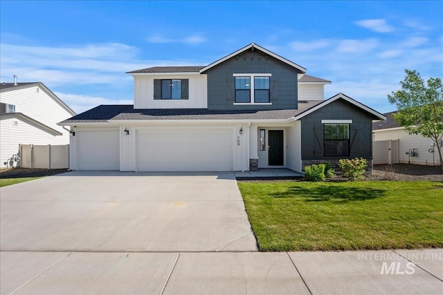 709 W Smoky Quartz St, Kuna, ID 83634 - view of front of house featuring driveway, a garage, and board and batten siding