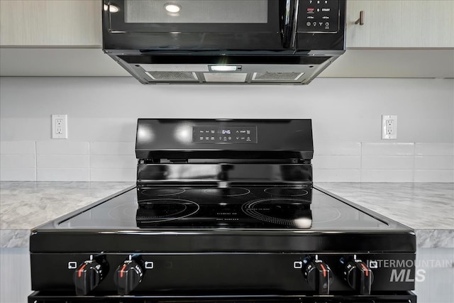 709 W Smoky Quartz St, Kuna, ID 83634 - kitchen view of black appliances, decorative backsplash, and light countertops