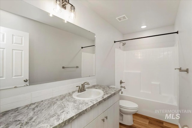 709 W Smoky Quartz St, Kuna, ID 83634 - bathroom with vanity, toilet, shower / bathtub combination, and wood finished floors