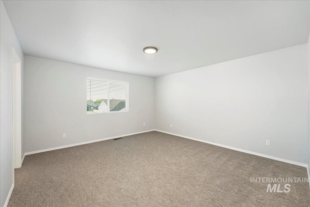 709 W Smoky Quartz St, Kuna, ID 83634 - unfurnished room featuring dark carpet and baseboards