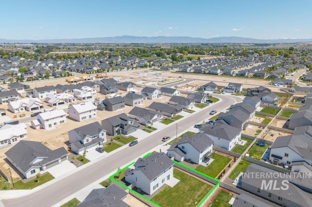 709 W Smoky Quartz St, Kuna, ID 83634 - aerial perspective of suburban area with property parcel outlined and a mountain backdrop
