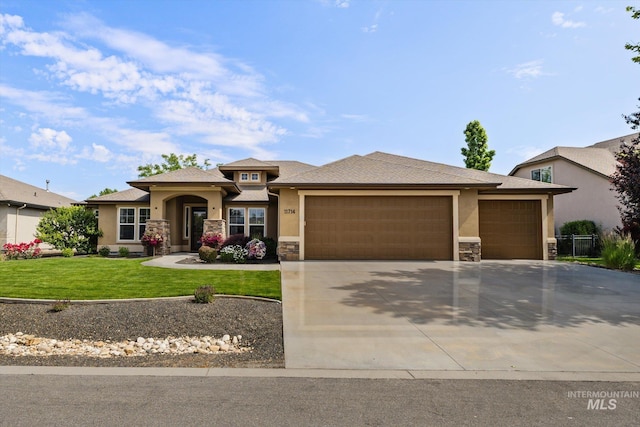 11714 W Pinewood River Ln, Star, ID 83669 - prairie-style house featuring stucco siding, stone siding, an attached garage, and concrete driveway