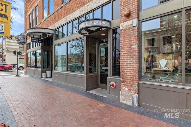 doorway to property featuring brick siding