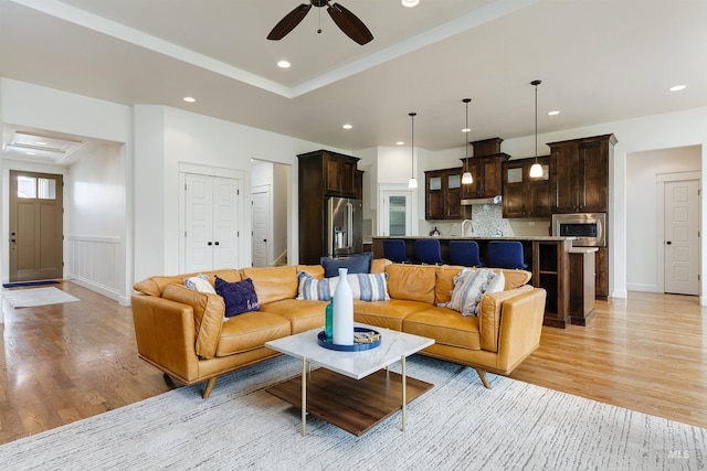 6859 N Topaz Jewel Pl, Meridian, ID 83646 - living room featuring light wood-style floors, ceiling fan, a wainscoted wall, and recessed lighting