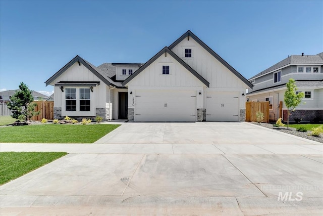 modern farmhouse style home with a front yard and a garage