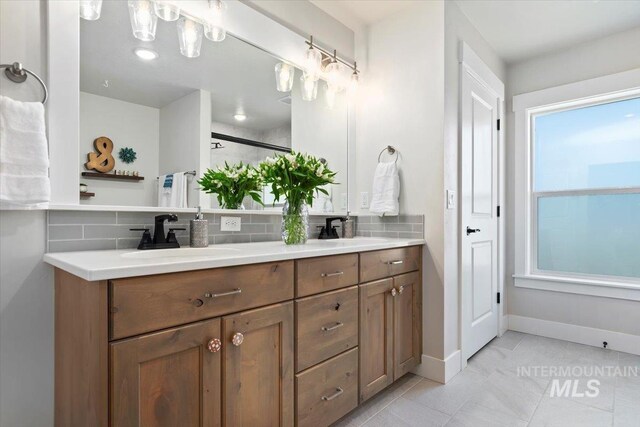 1867 W Wind Drift St, Meridian, ID 83646 - bathroom with backsplash, double vanity, tile patterned flooring, and baseboards