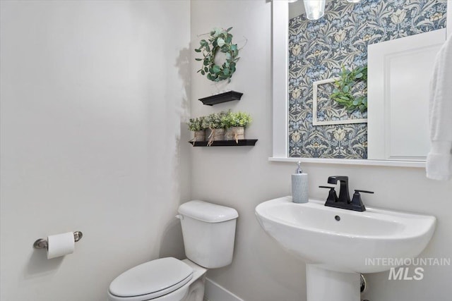 1867 W Wind Drift St, Meridian, ID 83646 - bathroom featuring wallpapered walls, baseboards, toilet, and a sink