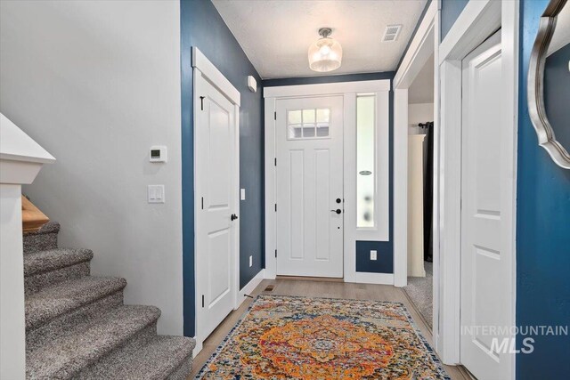 1867 W Wind Drift St, Meridian, ID 83646 - entryway featuring light wood-style flooring, stairs, and baseboards