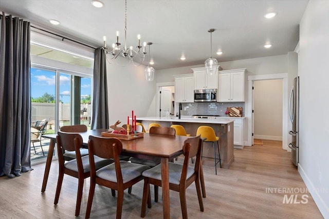 1867 W Wind Drift St, Meridian, ID 83646 - dining space with light wood-style floors, a chandelier, baseboards, and recessed lighting