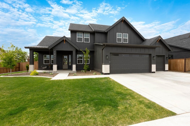 craftsman house featuring a front yard, covered porch, and a garage