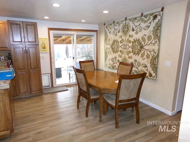 1835 Lincoln St, Mountain Home, ID 83647 - dining space with recessed lighting, light wood-style flooring, a textured ceiling, and baseboards