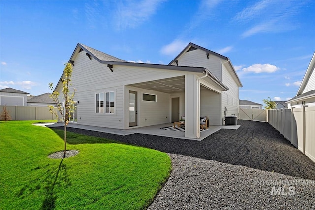 rear view of property with a patio, central AC, and a lawn