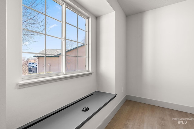 interior space featuring wood finished floors and baseboards