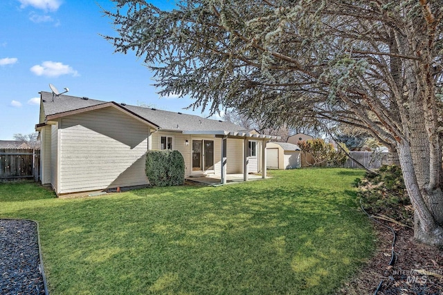 back of property featuring an outbuilding, a yard, a patio area, and a fenced backyard