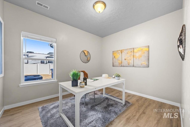 120 Pilgrim Way, Middleton, ID 83644 - office area featuring wood finished floors, baseboards, and a textured ceiling