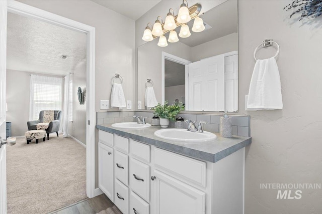 120 Pilgrim Way, Middleton, ID 83644 - full bathroom with double vanity, a textured ceiling, baseboards, and a chandelier