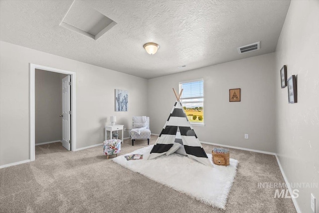 120 Pilgrim Way, Middleton, ID 83644 - workout area featuring carpet flooring, a textured ceiling, baseboards, and attic access